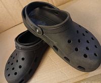 Side and top view of black Crocs clogs