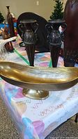 Front view of gold pedestal bowl and two urn candle holders