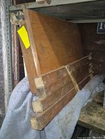 Rectangular oak desktop and bundled stretcher boards on shelf