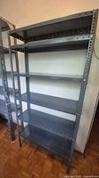 Full frontal view of gray steel shelving unit showing five shelves