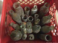 Top view of crate filled with assorted glass bottles
