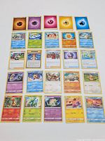 Top-down view of all 24 Pokémon cards arranged in grid