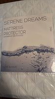 Front of package showing Serene Dreams King mattress protector branding and waterproof feature