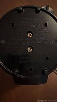 Underside of percolator showing model, voltage and wattage information