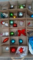 Top view of storage box showing assorted ornaments arranged in compartments