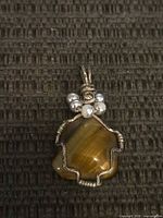 Front view of tiger eye wire-wrapped pendant