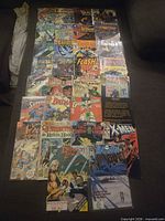 Top-down view of entire assortment of approx. 30 comics including Batman, Flash, X-Men, Green Lantern, etc.