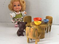 Goldilocks doll, bear, table with three bowls, three chairs