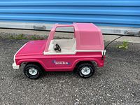 Side view of pink Tonka Bronco with white roof and pull handle