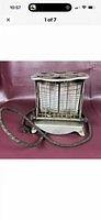 Front view of antique electric toaster with cord