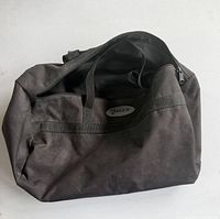 Front view of black Galls gear bag showing logo and handles