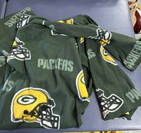 Overall view of folded Green Bay Packers fleece snuggie showing colour and pattern
