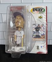 Front view of packaged Randy Johnson Play Makers bobblehead and backing card