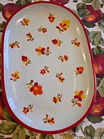 Top view of platter showing floral pattern and red rim