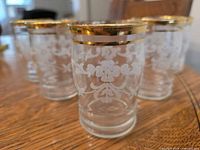 Five Libbey juice glasses showing etched pattern and gold rims