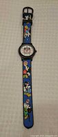 Full view of watch showing entire strap and dial