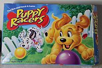 Front of Puppy Racers board game box displaying artwork, age range, and 1999 copyright