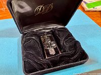 Bar within open velvet case showing overall presentation