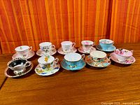 All ten teacup and saucer sets displayed