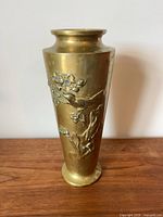 Full view of brass vase front showing raised bird and floral design