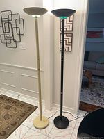 Beige and black torchiere floor lamps powered on
