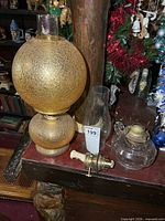 All items grouped: amber crackle globe lamp, finger lamp body, spare burner, clear chimney visible