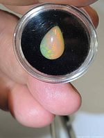 Pear-shape opal in capsule first angle