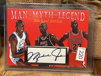 Front of Man Myth Legend Michael Jordan card with printed autograph and images of Jordan in three uniforms