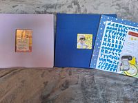 Purple and blue scrapbooks side by side front covers shown