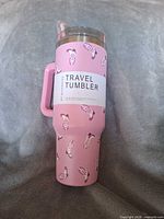 Front view showing pink tumbler, cowboy boots pattern, retail band