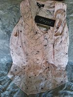 Full view of pink abstract print sleeveless dress with tags