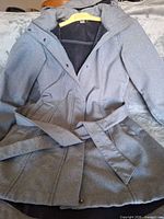 Front view of gray hooded belted coat on hanger
