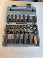 Open case showing rows of shallow and deep sockets and universal joint
