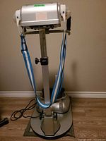 Full view of Accuciser belt massager on stand with belts and foot platform
