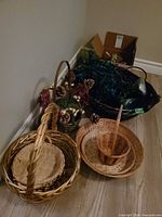 Group of baskets, pinecone decor, and lights piled in corner