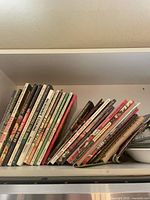 Stack of Better Homes and Gardens cookbooks on shelf