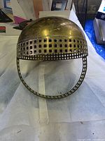 Top of brass handled planter showing domed shape and lattice band