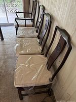 Row of chairs showing side profile, cushions, finish