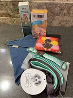 All items overview: spray, diapers, bandana, tissues, leash, collar