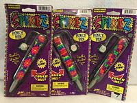 Front view of three sealed Spikez Punky Pens on purple packaging