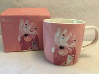 Mug front view beside retail box