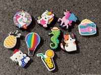 All ten colourful shoe charms laid out on surface