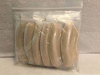 Sealed zip-lock bag containing six pairs beige heel grip liners