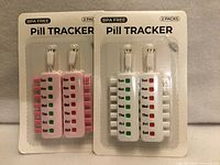 Front view of two blister-pack pill trackers showing color variants and "BPA FREE" and "2 PACKS" labels