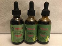 Front view of three sealed bottles showing brand and product details