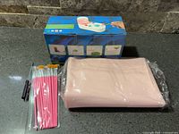 Entire lot showing boxed paint station, sealed silicone mat, paint brushes, and brush cleaner