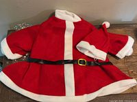 Santa-style jacket and hat laid flat showing color, trim and belt detail