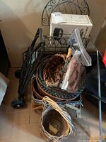 Overall view showing metal rack with boxed French press, foldable luggage carrier and nested wicker baskets