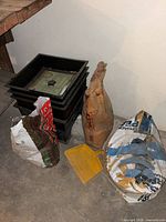 Stacked Worm Factory trays, three soil bags, dustpan