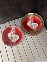 Two Marilyn Monroe collector plates, one framed, one unframed